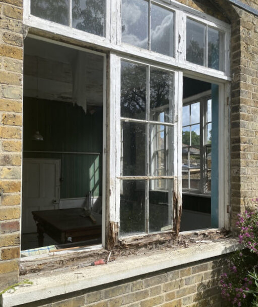 Severe timber rot in a window frame before restoration